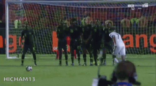 Soccer Player Number 7 Kicking Ball Into Goal