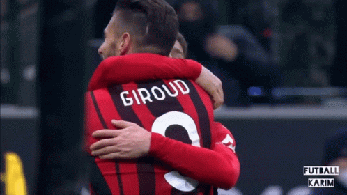 Soccer Player Number 9 Hugging Another Player