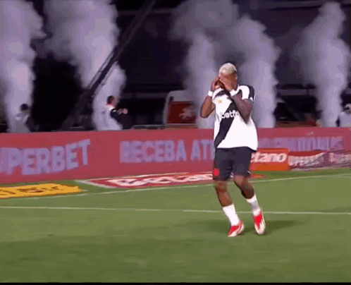 Soccer Player on Field With Smoke in Stands