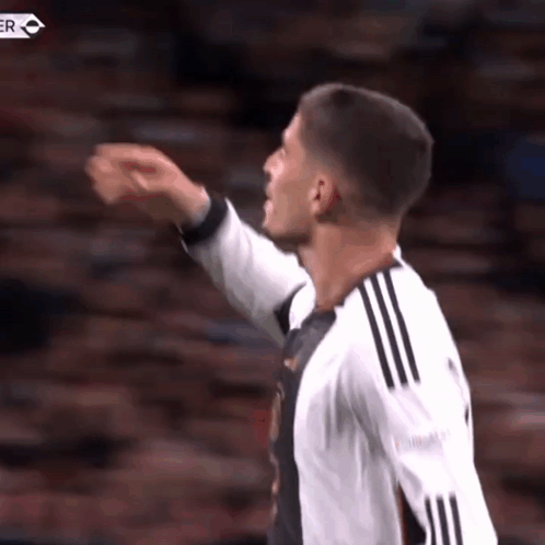 Soccer Player Pointing in Black and White Jersey
