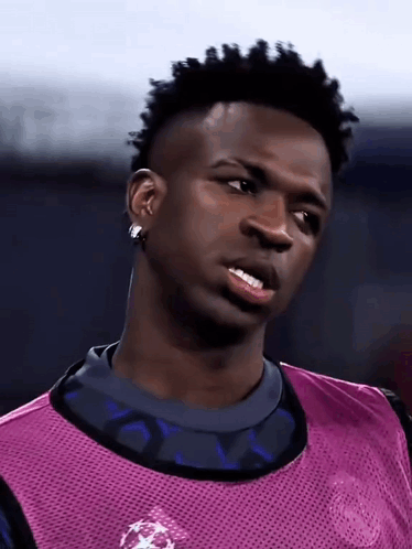 Soccer Player Purple Vest And Earrings Looking Sideways GIF