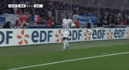 Soccer Player Running in Front of EDF Sign