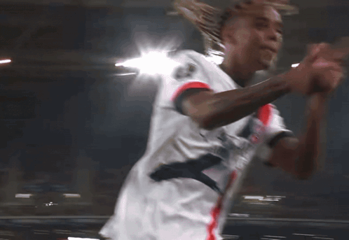 Soccer Player Running in White Qatar Shirt