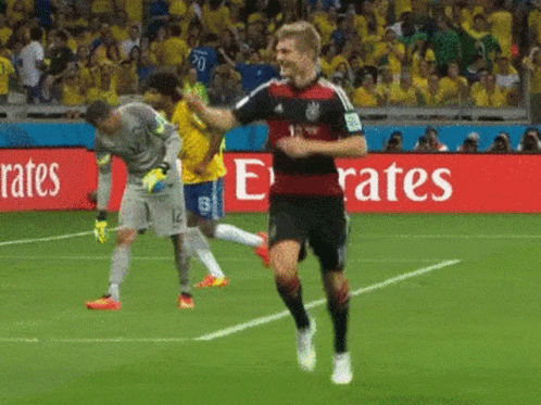 Soccer Player Running On Field In Front Of Emirates Sign GIF