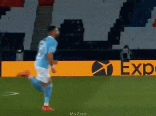 Soccer Player Running on Field Past Expedia Ad