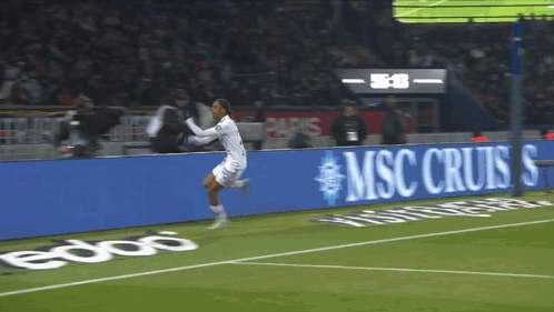 Soccer Player Running on Field With MSC Cruises Sign