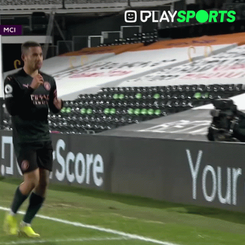 Soccer Player Running on Field with Scoreboard Sign