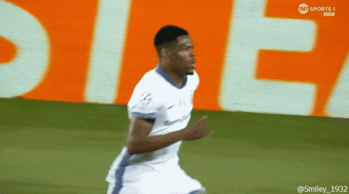 Soccer Player Running Past Orange TNT Sports Sign