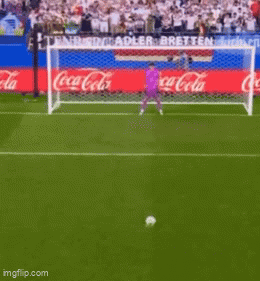 Soccer Player Running Towards Goal With Coca Cola Ads