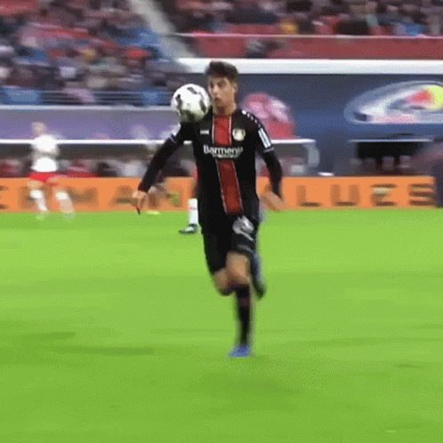 Soccer Player Running with Ball on Head