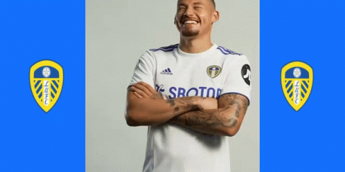 Soccer Player Standing With Arms Crossed Blue Background