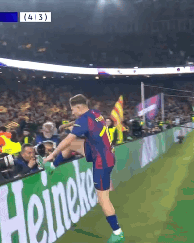 Soccer Player Stretching Leg in Front of Heineken Ad