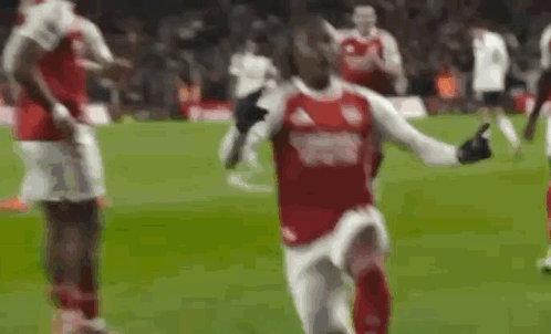 Soccer Player Thumbs Up Running on Field