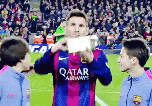 soccer player wearing a qatar airways jersey taking a picture of himself