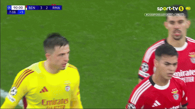 soccer player wearing a yellow jersey that says emirates on the front