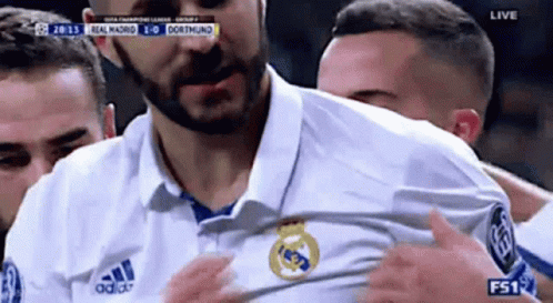 Soccer Player With Beard Hugged by Teammates