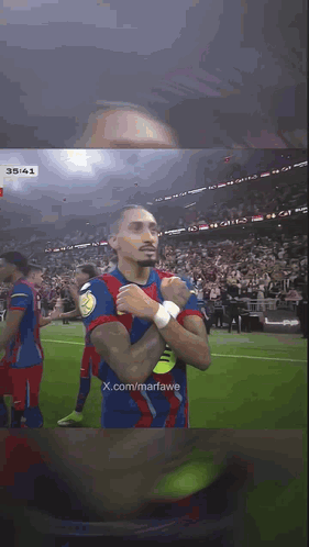 Soccer Player With Hands Folded In Front Of Crowd GIF