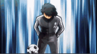 Soccer Player With Hands on Hips Beside Soccer Ball