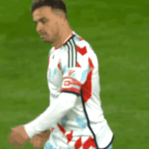 Soccer Player With Letter O on Red Blue Striped Jersey