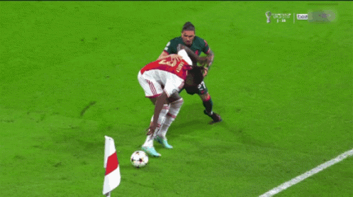 Soccer Player With Number 27 Kicks Ball