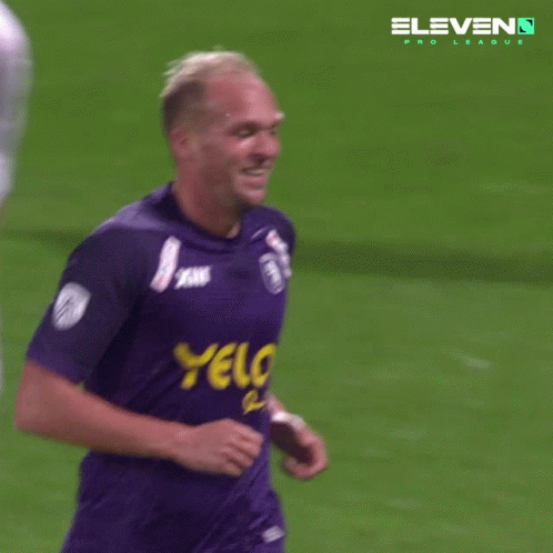 Soccer Player with Yellow Yelo on Purple Jersey