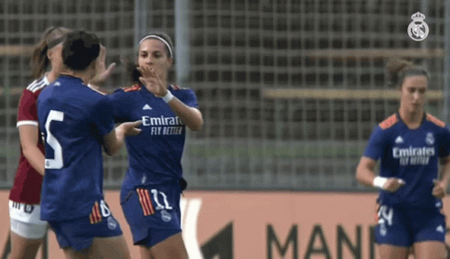 Soccer Players Celebrating Goal in Emirates Jerseys