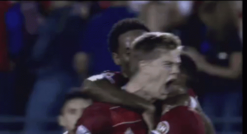 Soccer Players Celebrating Goal in Red