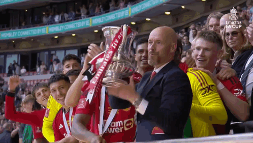 Soccer Players Holding Emirates Trophy