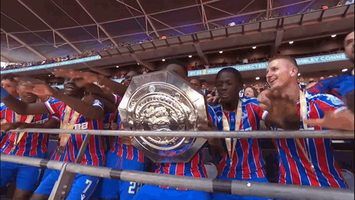 Soccer Players Holding Trophy at Wembley