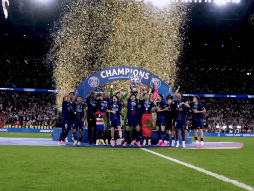 Soccer Players Holding Trophy Under Champions Arch