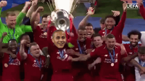 Soccer Players Holding Trophy with Mask