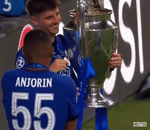 Soccer Players Holding Trophy