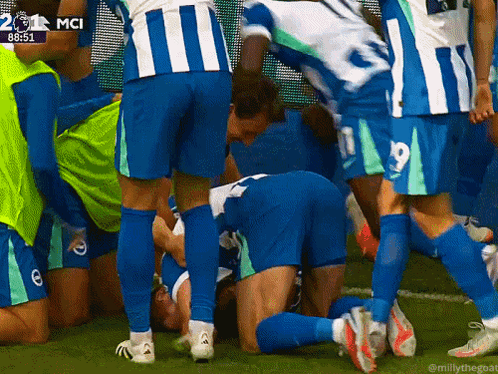 Soccer Players Huddle Around Number 19 GIF