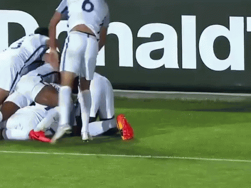 Soccer Players Huddled in Front of McDonald's Sign