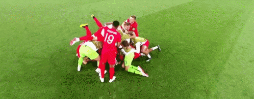 Soccer Players Huddled on Field