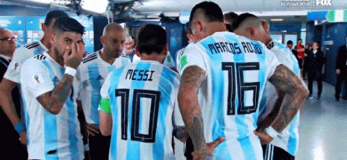 Soccer Players Huddled With Messi in Locker Room