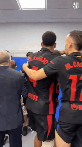 Soccer Players Hugging Number 17 on Back