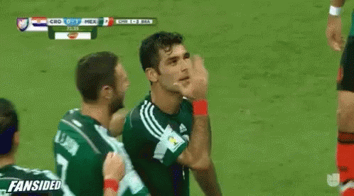 Soccer Players Hugging on Field H. Moreno
