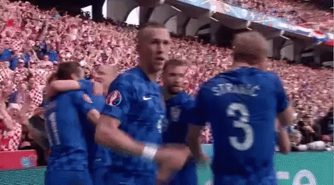 Soccer Players Hugging on Field