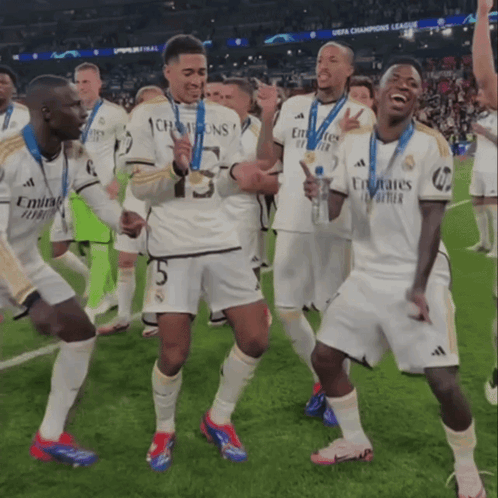 Soccer Players in Emirates Jerseys Celebrate on Field