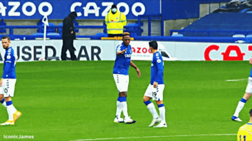 Soccer Players in Front of Gazoo Sign