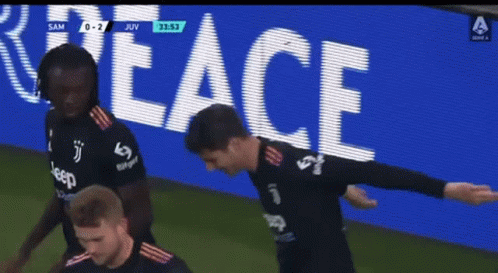Soccer Players in Front of Peace Sign