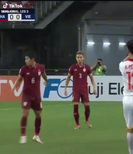 Soccer Players in Front of TikTok Banner