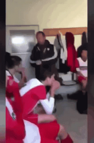 Soccer Players in Locker Room With Heads Down