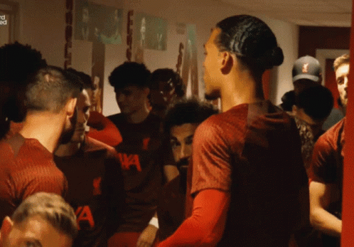 Soccer Players in Locker Room with Shirt Saying a