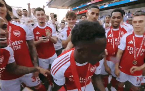 Soccer Players in Red Jerseys With Emirates Fly Better