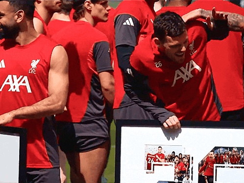 Soccer Players in Red Shirts With AXA