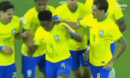 Soccer Players In Yellow And Blue Celebrating Goal GIF