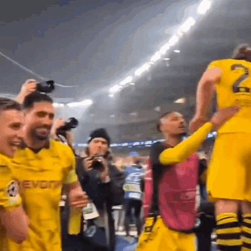 Soccer Players in Yellow Jerseys Celebrating Victory