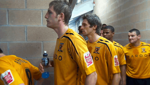 Soccer Players in Yellow Shirts With Karoo